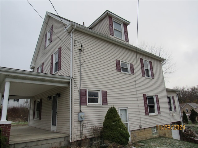 view of property exterior featuring covered porch