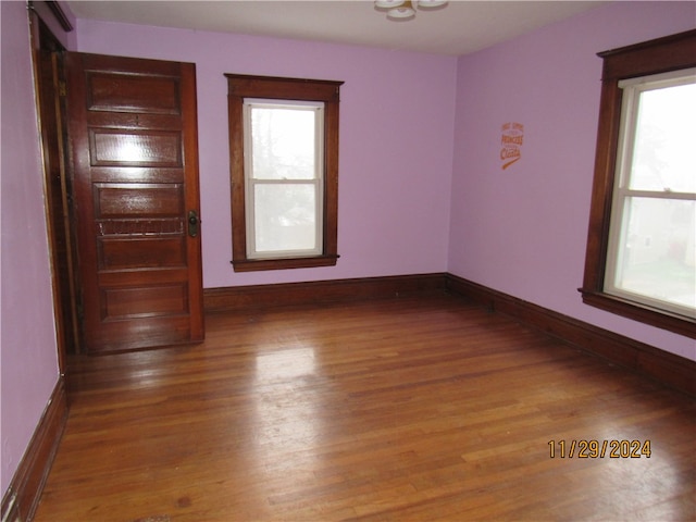 empty room featuring hardwood / wood-style floors and a healthy amount of sunlight