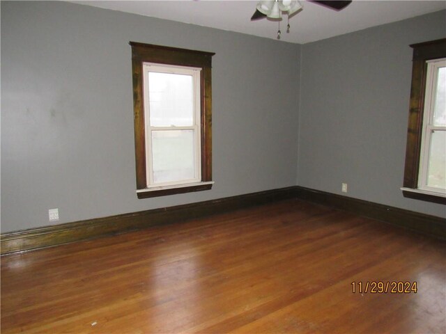 spare room with ceiling fan and wood-type flooring