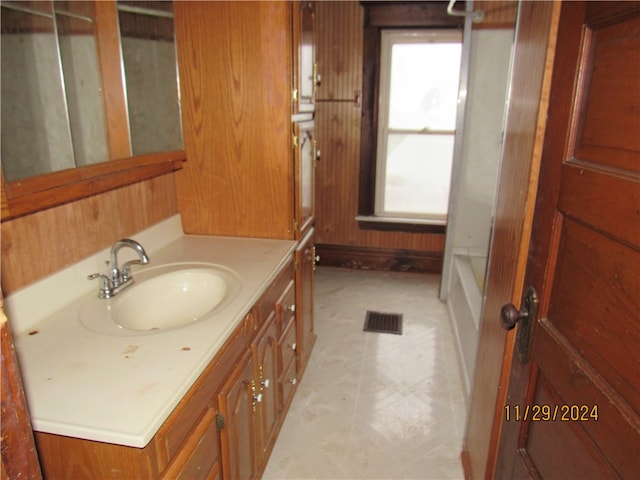 bathroom with vanity and shower with separate bathtub