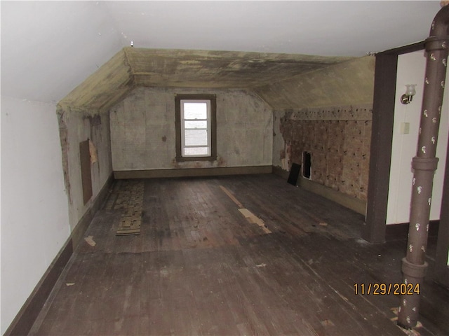 bonus room featuring dark hardwood / wood-style flooring and lofted ceiling