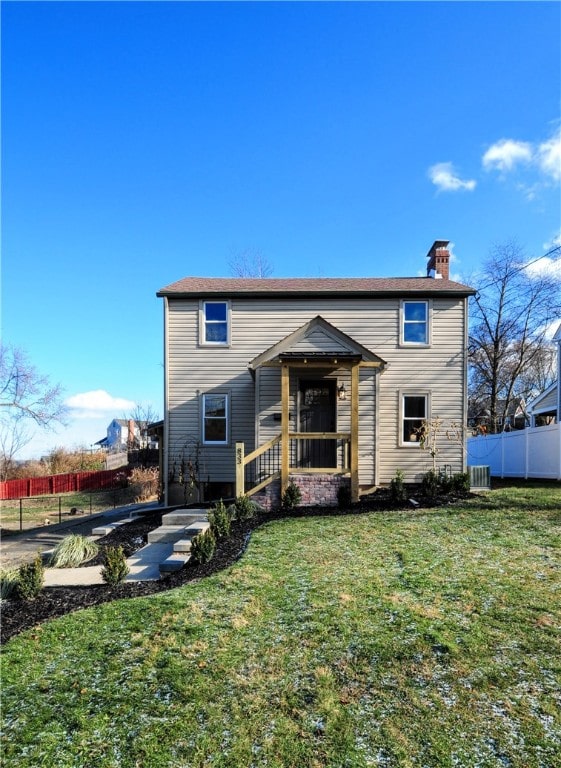 view of front property with cooling unit and a front lawn