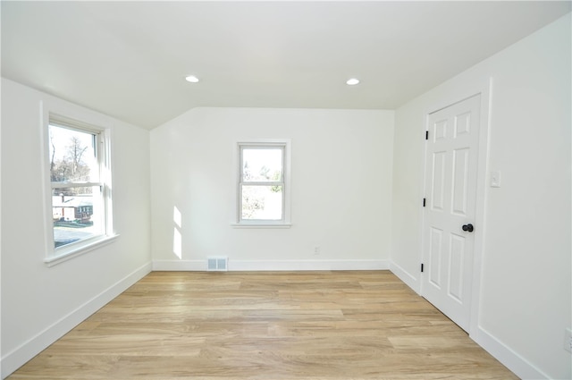 unfurnished room with light wood-type flooring and plenty of natural light