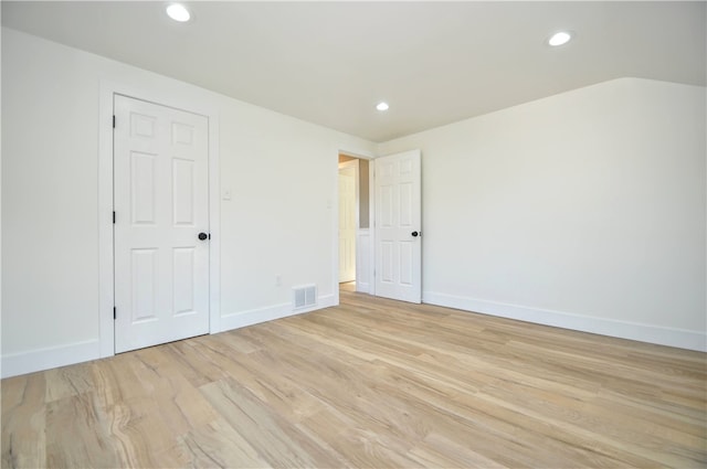 spare room featuring light hardwood / wood-style flooring