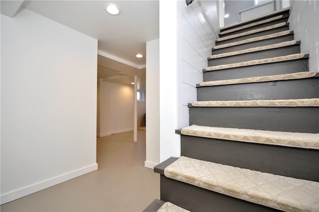 stairway featuring concrete floors