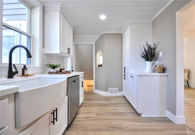 kitchen featuring sink, white cabinets, and light wood-type flooring