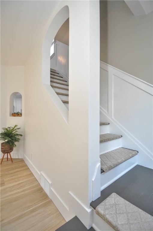 stairs with wood-type flooring