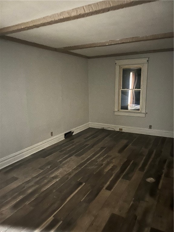 spare room with dark wood-type flooring