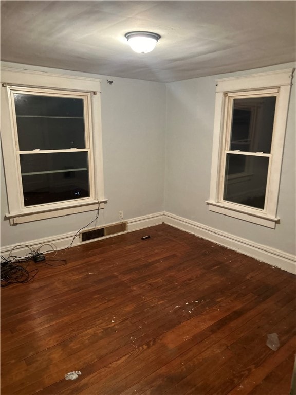 empty room with hardwood / wood-style flooring