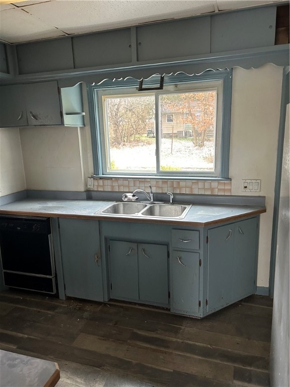 kitchen with dark hardwood / wood-style flooring, dishwasher, sink, and gray cabinets