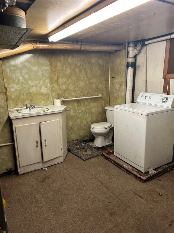 interior space featuring carpet floors, washer / clothes dryer, and sink