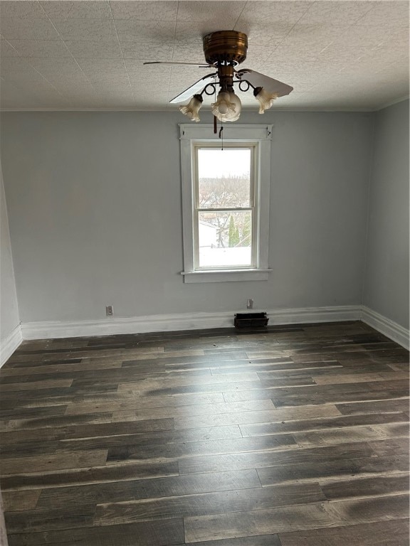 spare room featuring ceiling fan and dark wood-type flooring