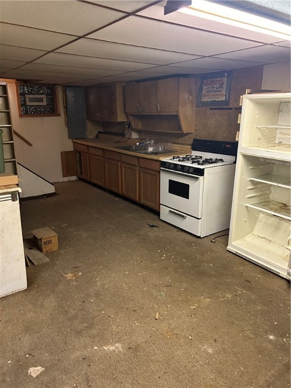 kitchen with a paneled ceiling, white range with gas cooktop, and sink