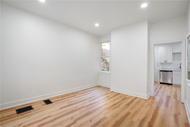 spare room with light hardwood / wood-style flooring