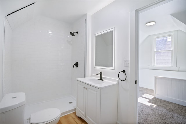 bathroom featuring tiled shower, radiator heating unit, vanity, and toilet