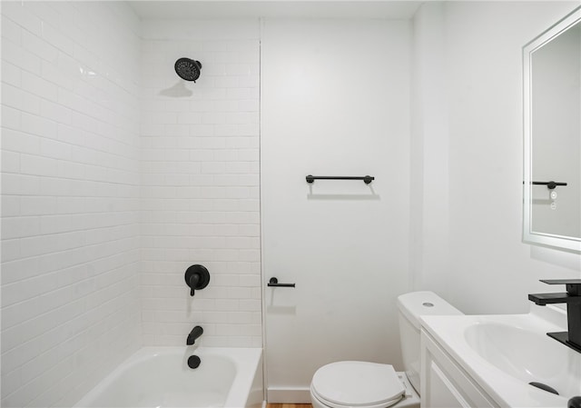 full bathroom with vanity, tiled shower / bath combo, and toilet