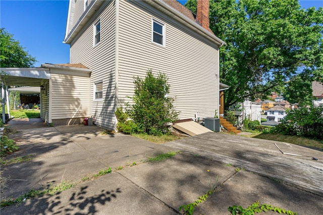 view of side of property featuring a patio area and central AC unit