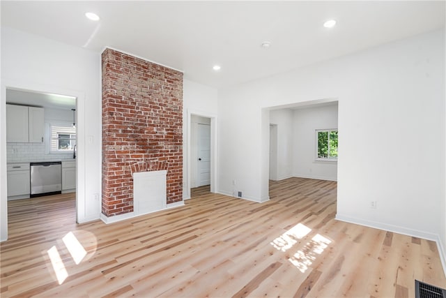 unfurnished living room featuring light hardwood / wood-style floors