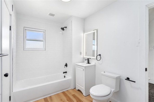 full bathroom with wood-type flooring, vanity, toilet, and tiled shower / bath