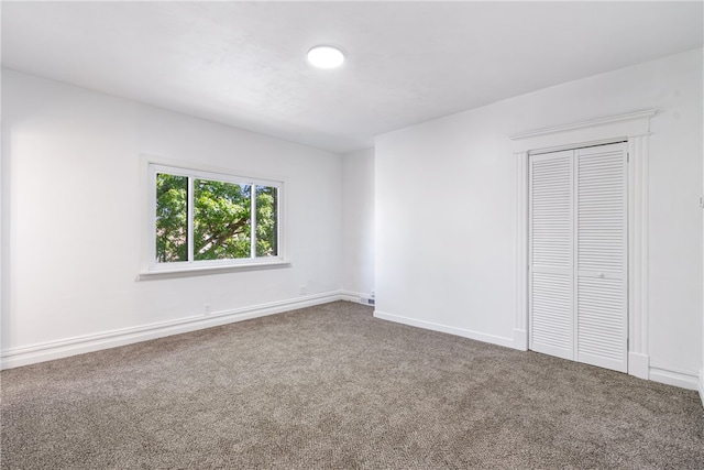 unfurnished bedroom featuring a closet and carpet