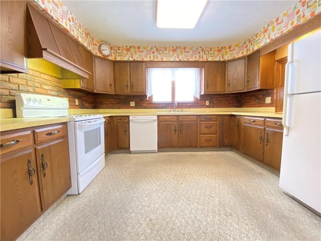 3240 E Lake Rd, Shenango, PA 16134 - kitchen featuring white appliances, brown cabinetry, light countertops, and custom exhaust hood
