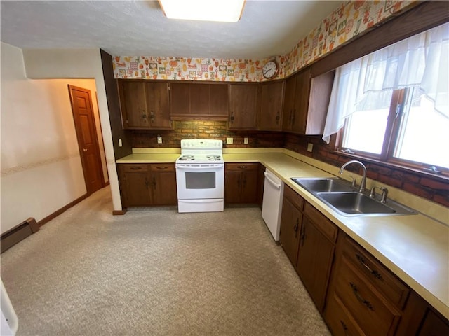 kitchen featuring backsplash, dark brown cabinets, sink, and white appliances