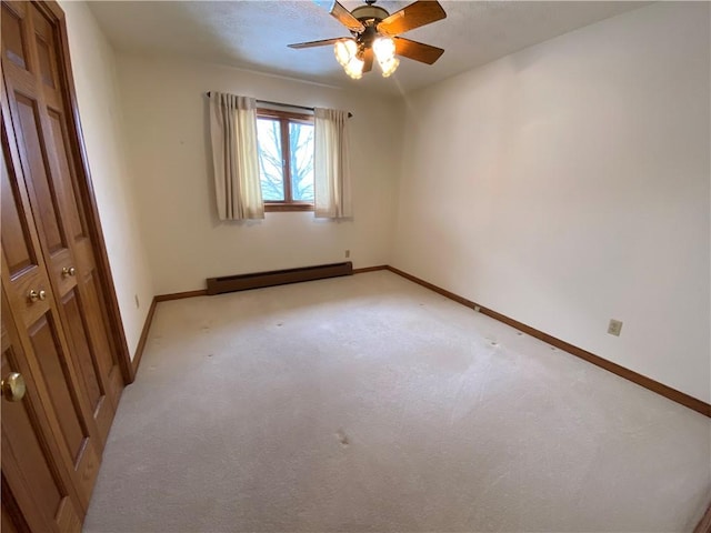 empty room with baseboard heating, ceiling fan, light carpet, and a textured ceiling