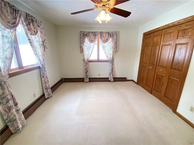 3240 E Lake Rd, Shenango, PA 16134 - unfurnished bedroom with a closet, light colored carpet, and ceiling fan