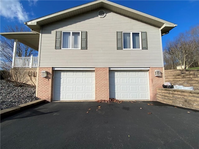3240 E Lake Rd, Shenango, PA 16134 - view of side of home featuring brick siding, an attached garage, and asphalt driveway