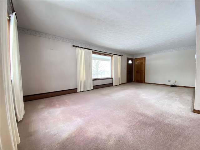 carpeted spare room with a textured ceiling