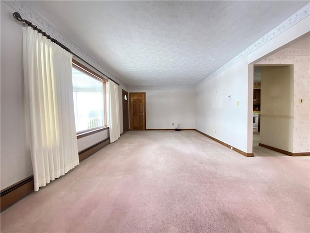 3240 E Lake Rd, Shenango, PA 16134 - spare room featuring light colored carpet, a textured ceiling, wallpapered walls, and baseboard heating