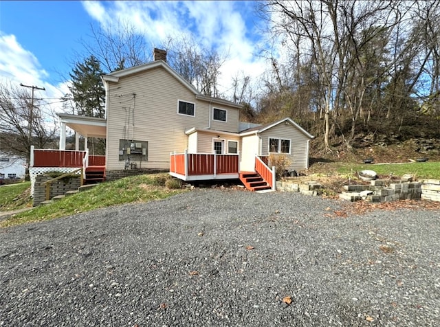 back of house featuring a deck