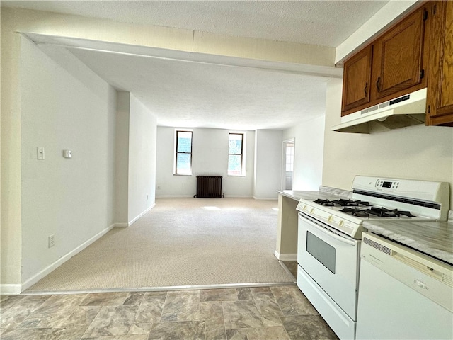 kitchen featuring radiator heating unit, white appliances, a textured ceiling, and light colored carpet