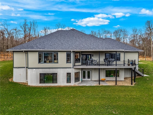 back of property featuring a yard, a wooden deck, and french doors