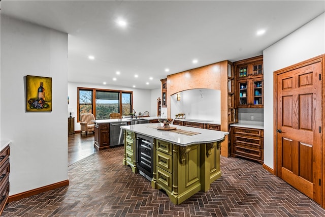 kitchen featuring dishwasher, a center island, beverage cooler, kitchen peninsula, and green cabinetry