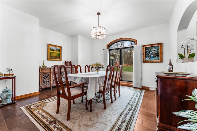 dining room featuring dark wood-type flooring and a notable chandelier