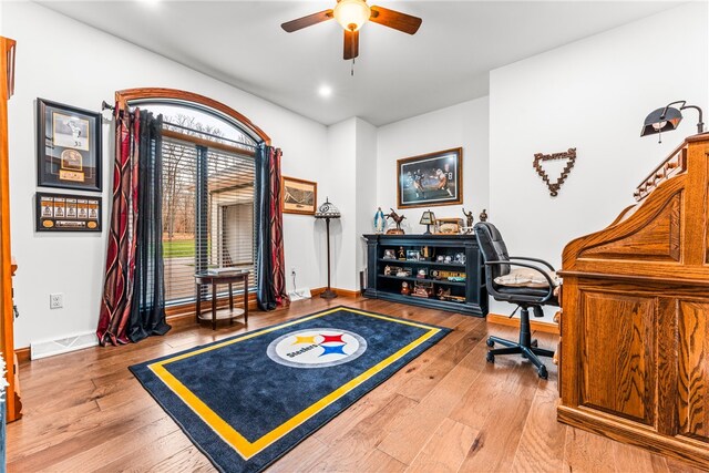 office space with ceiling fan and light hardwood / wood-style floors