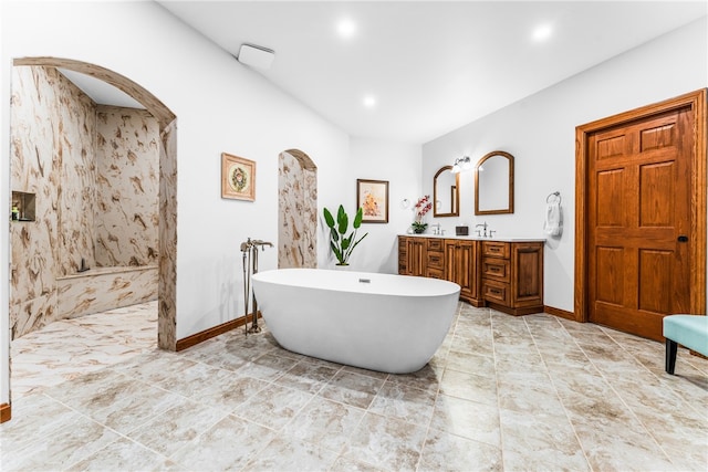 bathroom featuring vanity and independent shower and bath