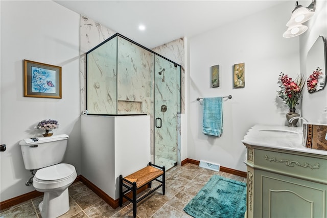 bathroom featuring vanity, toilet, and a shower with door