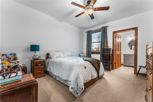 bedroom featuring ensuite bathroom, ceiling fan, and light colored carpet