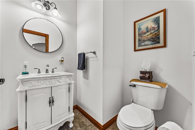 bathroom with tile patterned flooring, vanity, and toilet