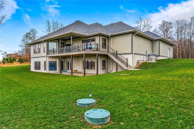 back of house with a deck and a lawn