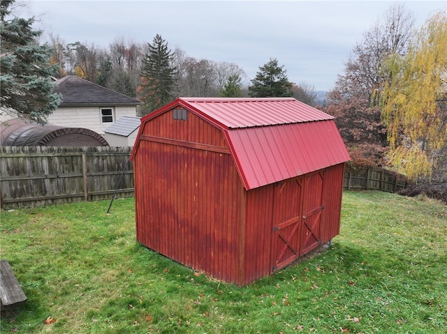 view of outbuilding with a yard