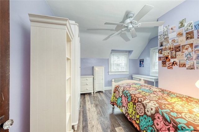 bedroom featuring dark hardwood / wood-style floors, ceiling fan, and lofted ceiling