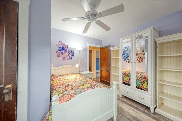 bedroom with ceiling fan, hardwood / wood-style floors, and french doors