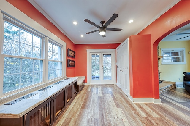 interior space with ceiling fan, french doors, light hardwood / wood-style floors, and ornamental molding