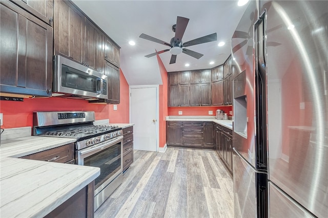 kitchen featuring appliances with stainless steel finishes, light wood-type flooring, dark brown cabinetry, and ceiling fan