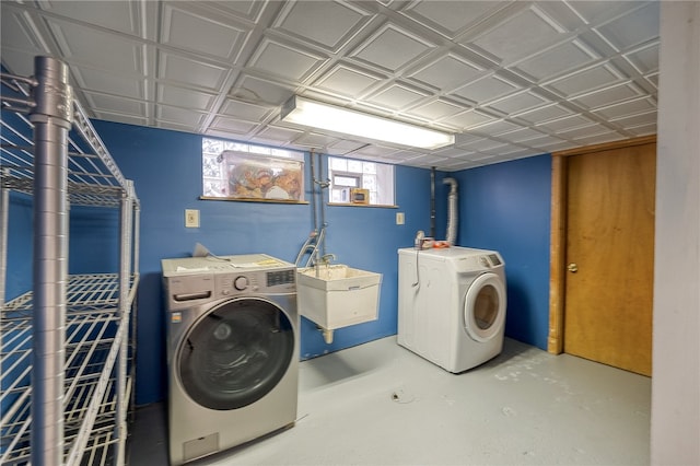 washroom featuring separate washer and dryer and sink