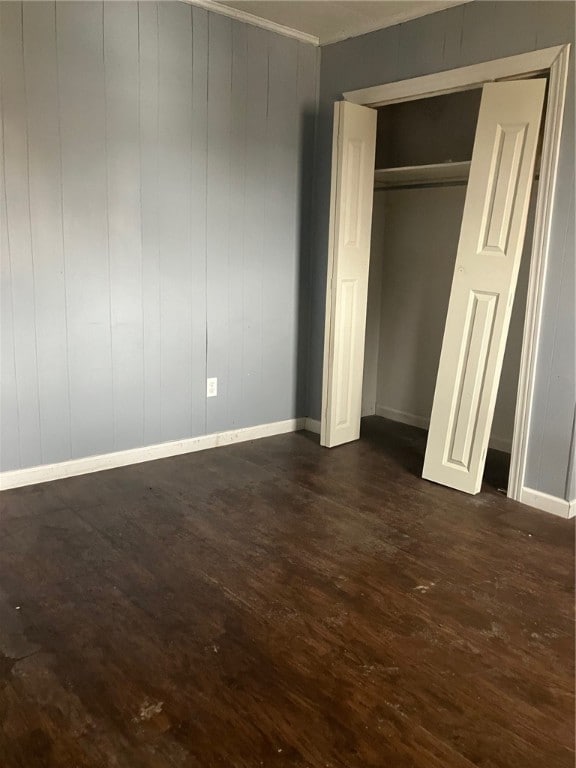 unfurnished bedroom with dark wood-type flooring