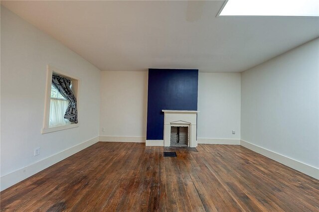 unfurnished living room featuring dark hardwood / wood-style flooring